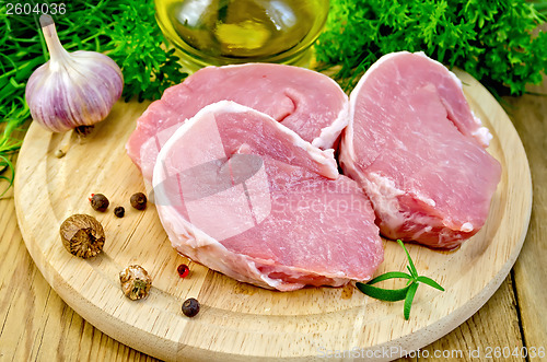 Image of Meat pork slices on a board with nutmeg