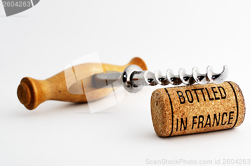 Image of vintage corkscrew and wine cork with inscription bottled in Fran