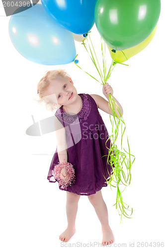 Image of Little cute girl in dress with air balloons