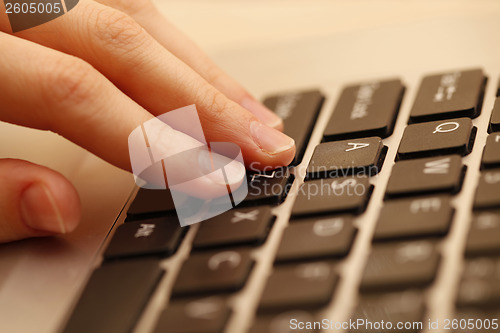 Image of Young woman working on laptop