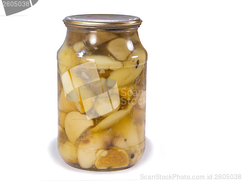 Image of Canned mushrooms in a glass jar on a white background.