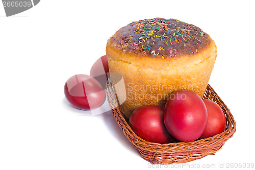 Image of Red Easter eggs and Easter bread in a basket on a white backgrou