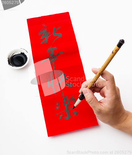 Image of Writing of chinese new year calligraphy, phrase meaning is bless