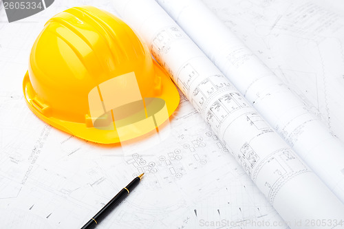 Image of Construction drawing and safety helmet