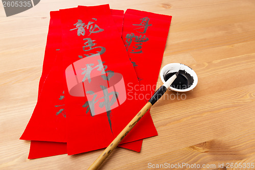 Image of Writing of lunar new year calligraphy, phrase meaning is blessin