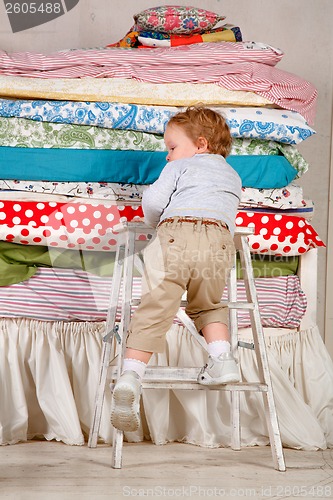 Image of Child climbs on the bed - Princess and the Pea.