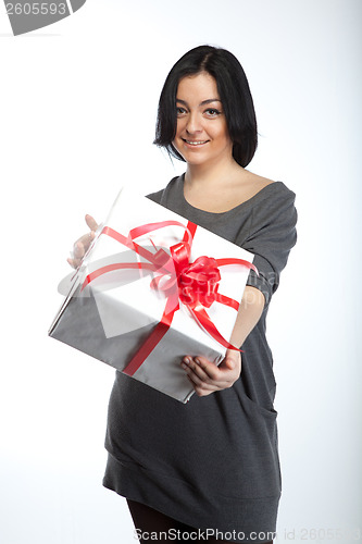 Image of Portrait of young smiling woman with gift  on white