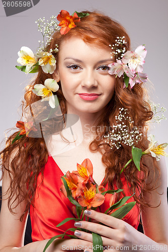 Image of Portrait of beautiful woman with spring flowers 