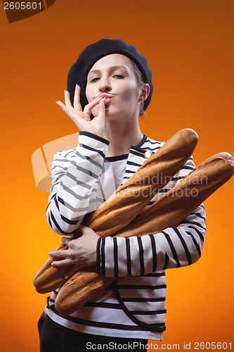 Image of woman holding baguettes and shows that taste is delicious