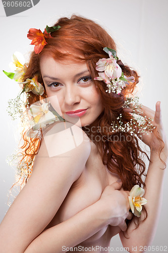 Image of Portrait of beautiful naked woman with spring flowers 