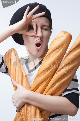 Image of woman holding baguettes isolated with ok sign on white