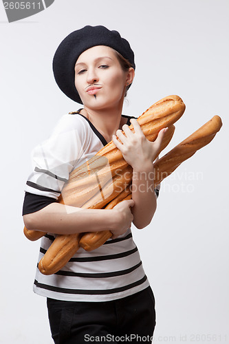 Image of woman holding baguettes isolated on white