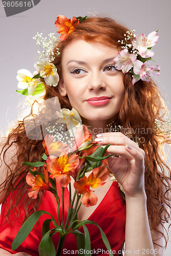 Image of Portrait of beautiful woman with spring flowers 