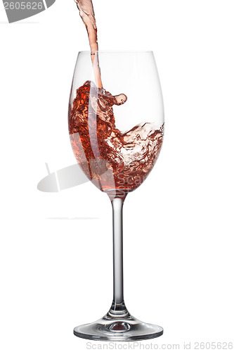 Image of Red wine pouring into glass with splash isolated on white