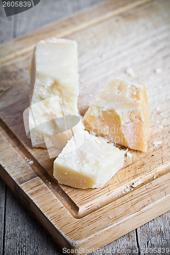 Image of parmesan cheese on wooden board 