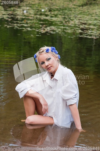 Image of Shot of beautiful woman sitting on water