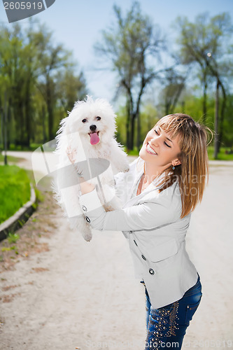 Image of Smiling woman with a dog