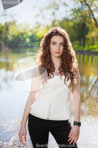 Image of Pretty brunette near the pond