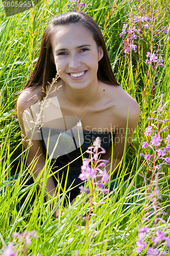 Image of Beautiful brunette woman in grass