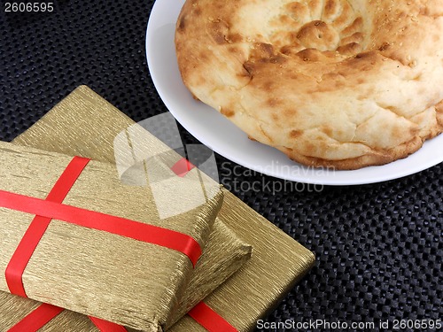 Image of sweet cookies and gold gift box with red ribbon