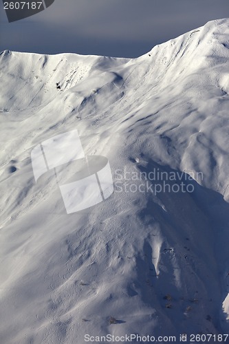 Image of Off-piste slope with trace from skis, snowboards and avalanche