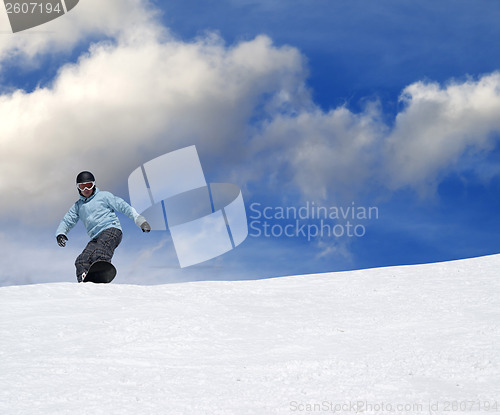 Image of Snowboarder on ski slope at nice day