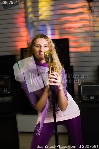 Image of Pretty woman singing at concert