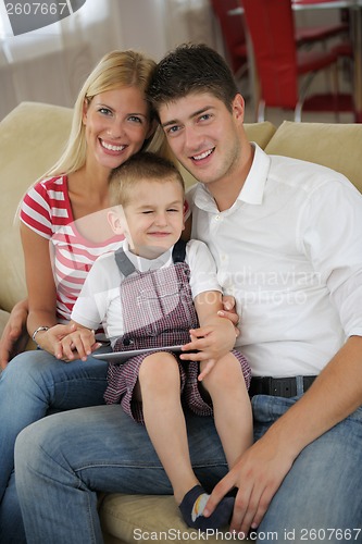 Image of family at home using tablet computer