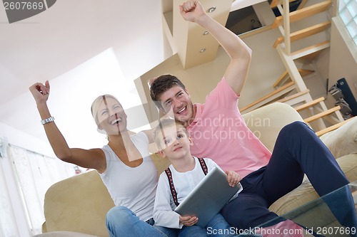 Image of family at home using tablet computer