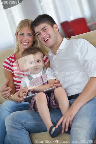 Image of family at home using tablet computer