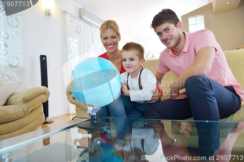 Image of family have fun with globe