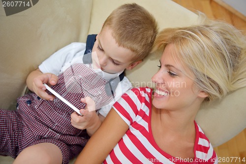 Image of family at home using tablet computer