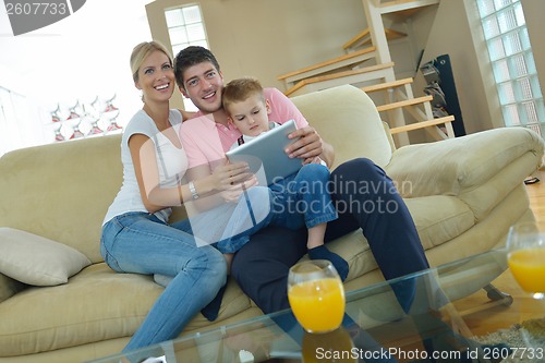 Image of family at home using tablet computer