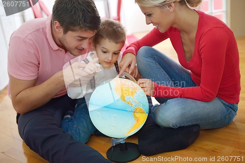 Image of family have fun with globe