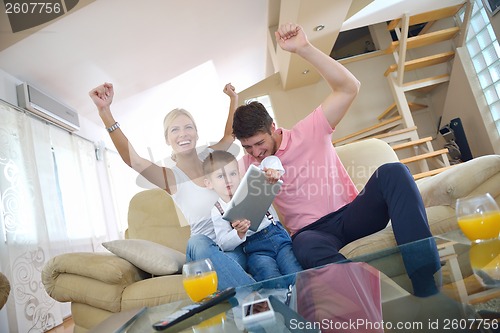 Image of family at home using tablet computer