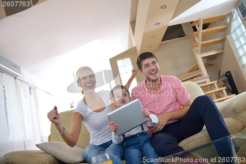 Image of family at home using tablet computer