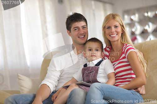 Image of family at home using tablet computer