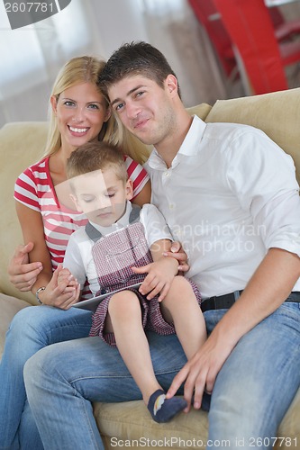 Image of family at home using tablet computer