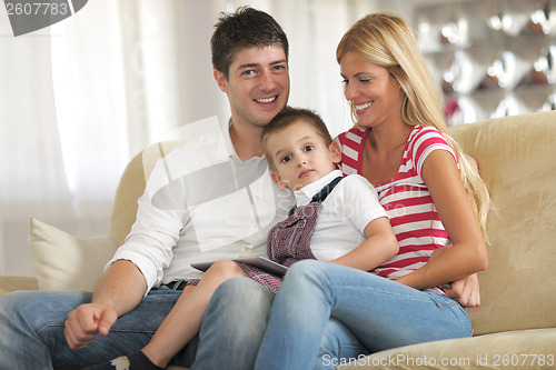 Image of family at home using tablet computer