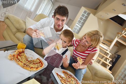 Image of family eating pizza