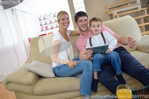 Image of family at home using tablet computer