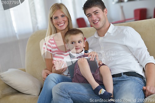 Image of family at home using tablet computer