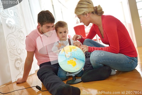 Image of family have fun with globe