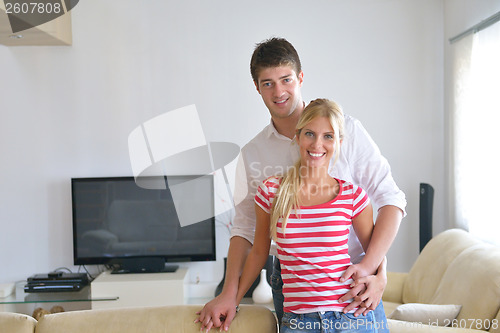Image of Relaxed young  couple watching tv at home