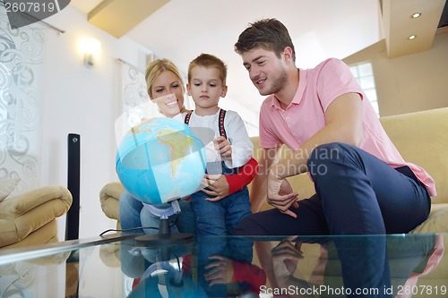 Image of family have fun with globe