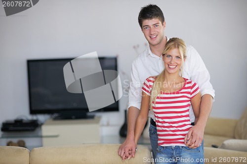 Image of Relaxed young  couple watching tv at home