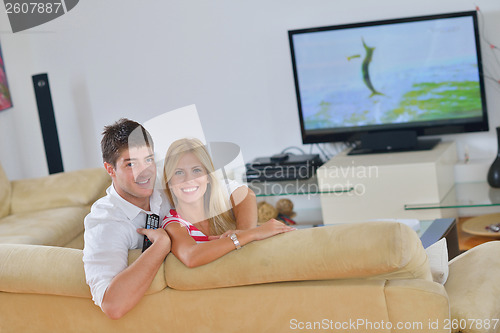 Image of Relaxed young  couple watching tv at home