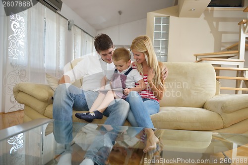 Image of family at home using tablet computer