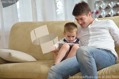 Image of family at home using tablet computer