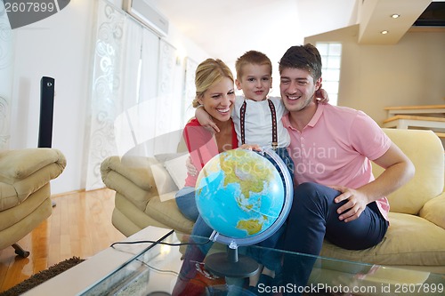 Image of family have fun with globe